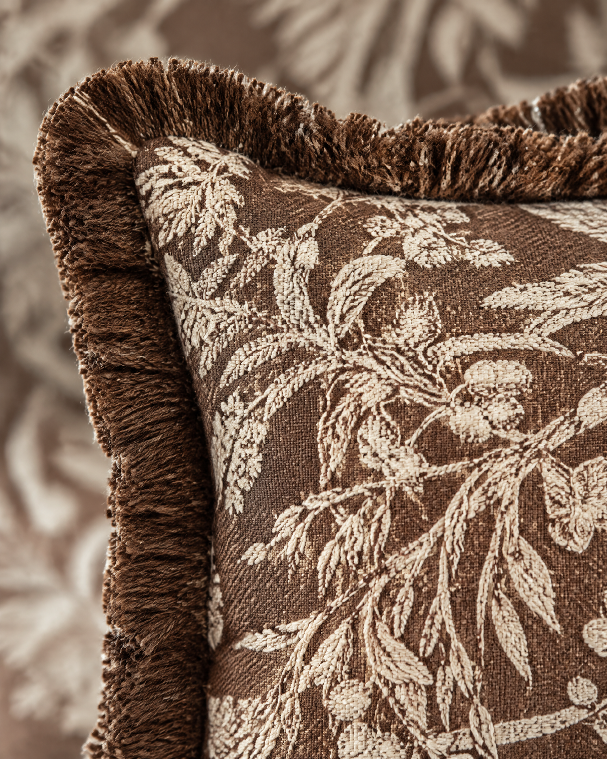 Close-up of chocolate botanical jacquard with brown fringe