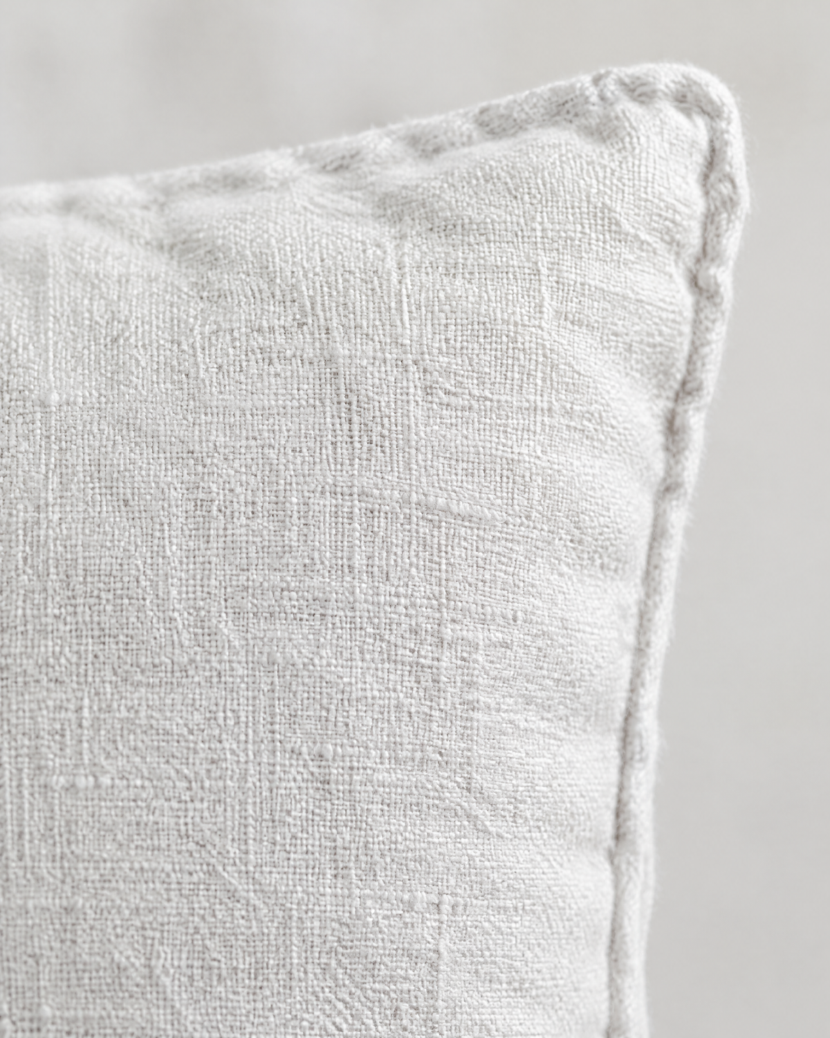 Close-up of white enzyme-washed slub fabric and self piping