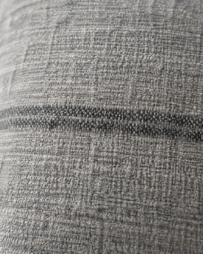 Macro close-up of a charcoal woven stripe on soft heathered grey hemp-cotton