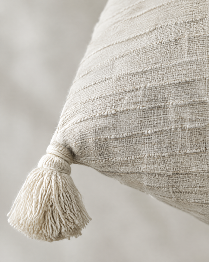 Close-up of ivory textured weave with corner tassel