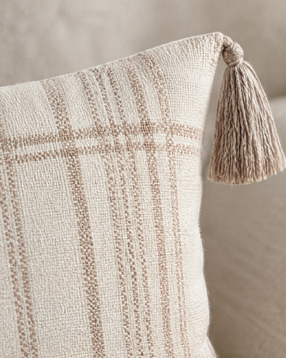 Macro close-up of fine printed terracotta check lines on ivory with a taupe corner tassel