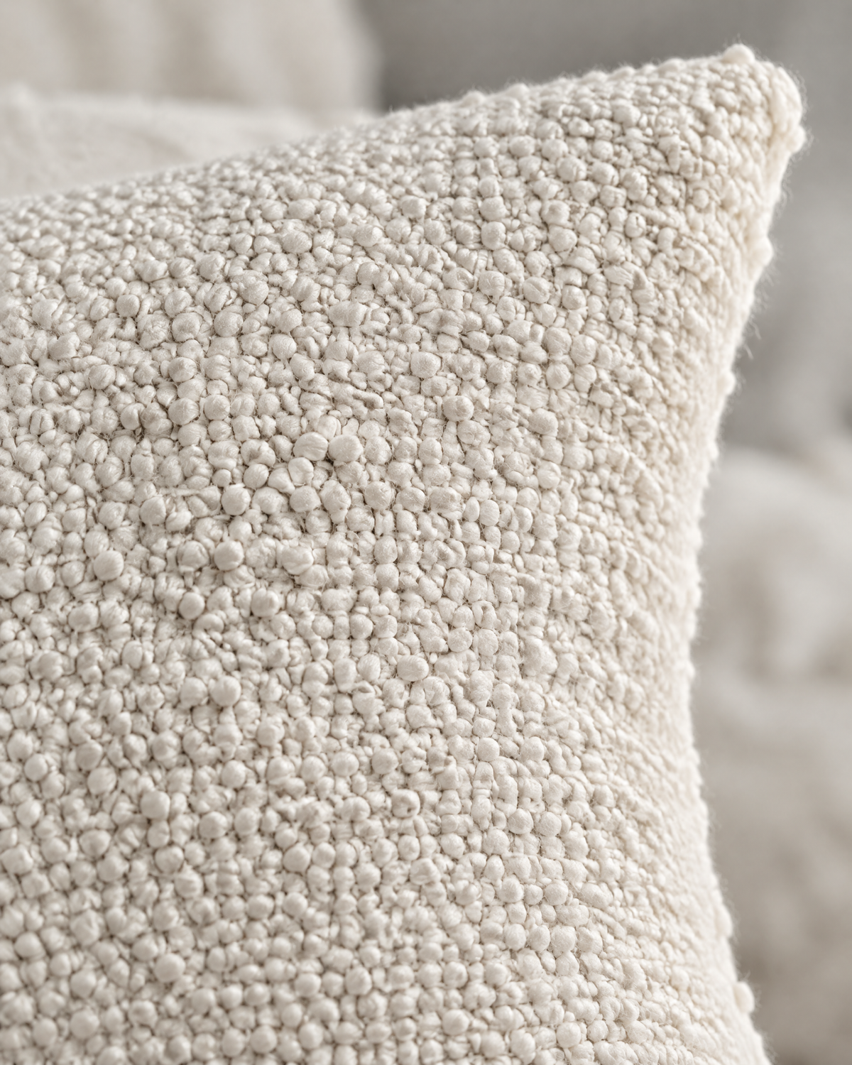 Macro close-up of the ivory jacquard, a nubby popcorn texture woven tone on tone