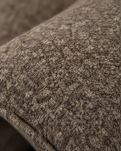 Macro close-up of the mocha boucle, heathered brown curls and slubs with the self-piped edge