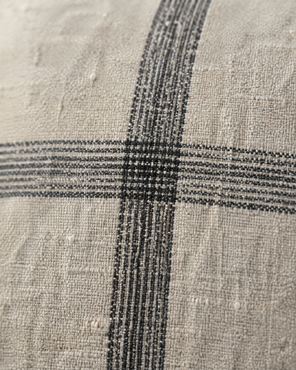 Macro close-up of the natural check, soft charcoal bands crossing on slubby oat linen cotton