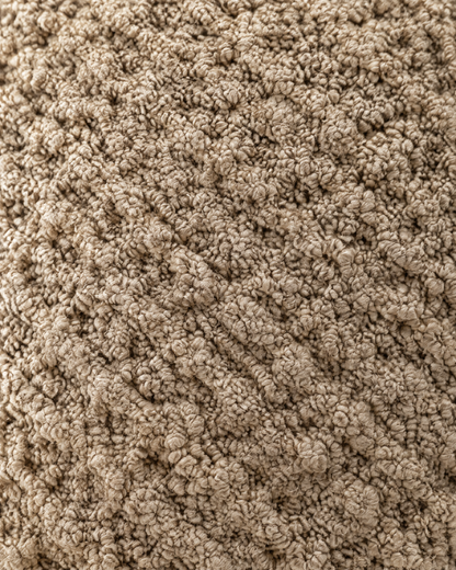 Close-up of natural jute knotted into a raised honeycomb relief