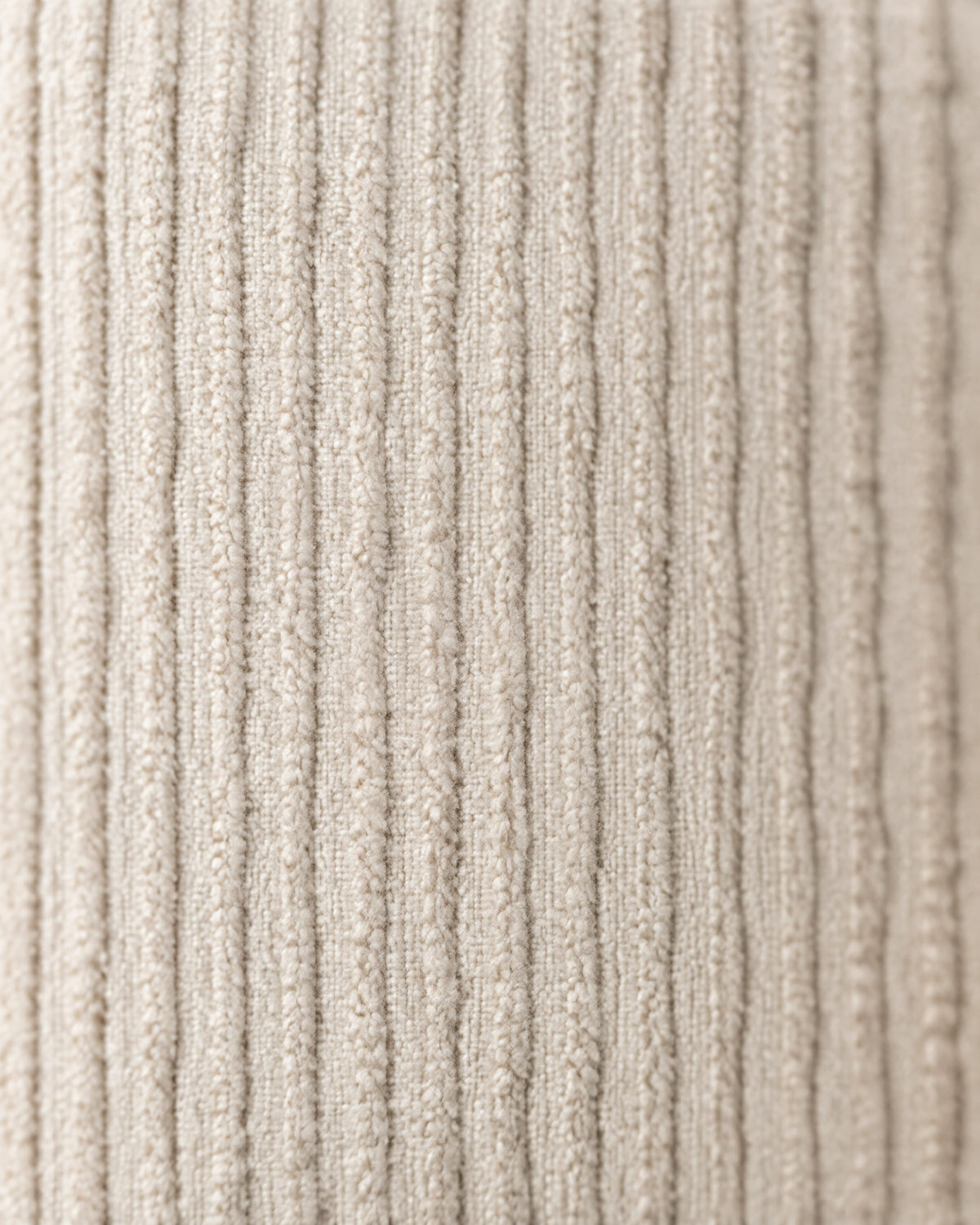 Macro close-up of the cream pinstripe jacquard, fine raised vertical ribs tone on tone