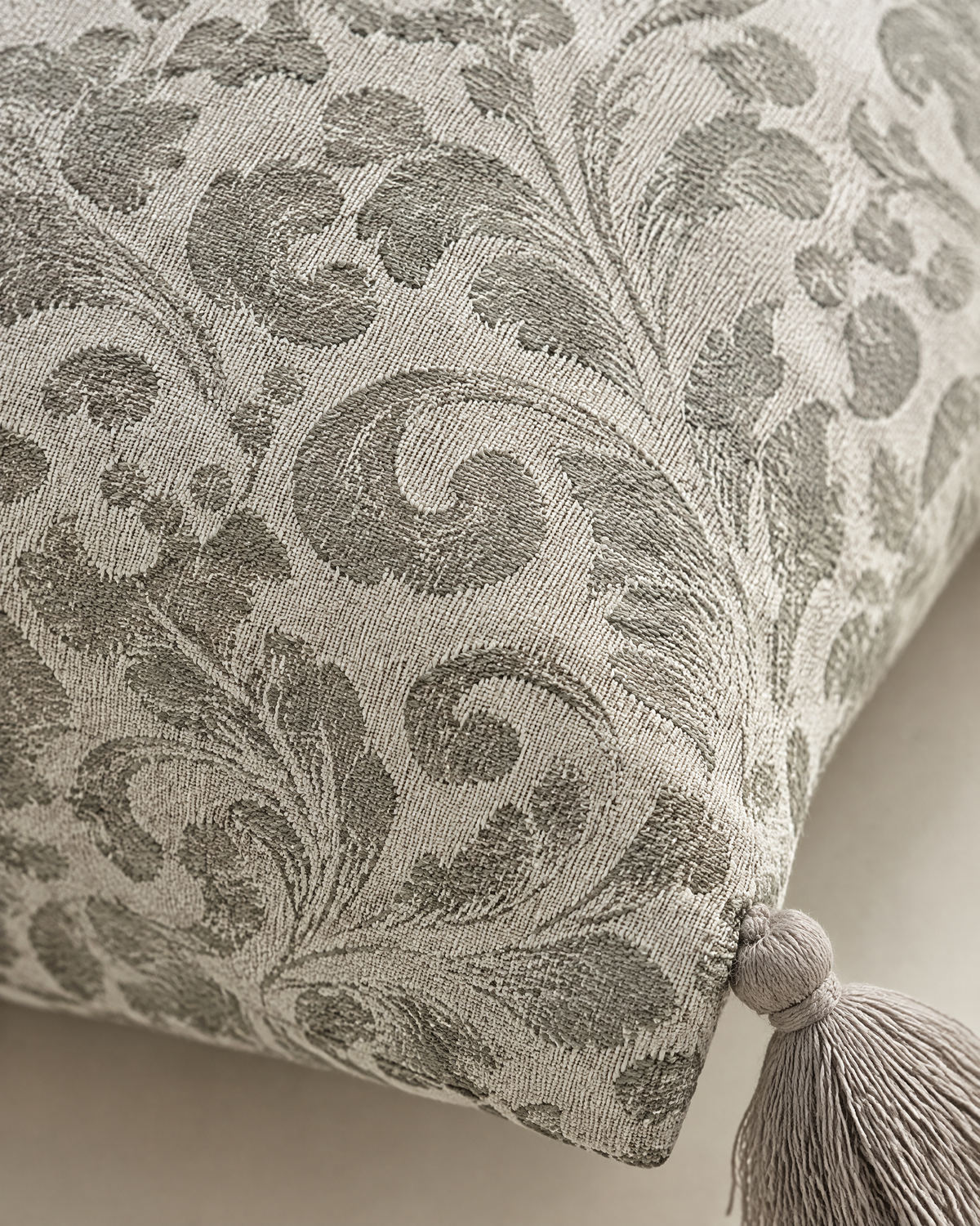 Close-up of sage grape leaf jacquard on ivory with tassel