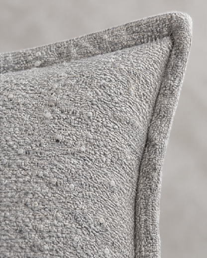 Macro close-up of the silver grey flecked jacquard, small ivory knots in a nubby grey weave with the flange