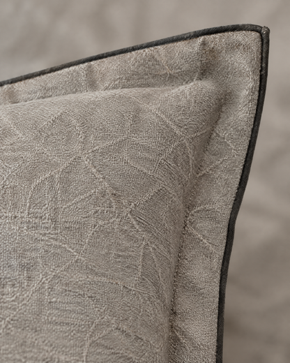 Macro close-up of the stone flanged jacquard, a faint crackle weave on stone linen with a thin charcoal binding