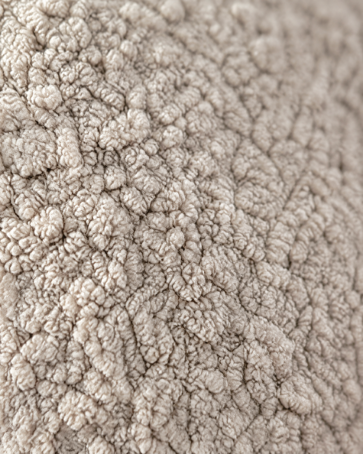 Close-up of beige curly teddy fleece