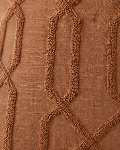 Macro close-up of tone-on-tone tufted ogee trellis on terracotta ramie