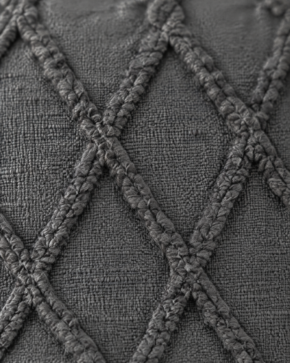 Close-up of raised tufted trellis lattice on charcoal