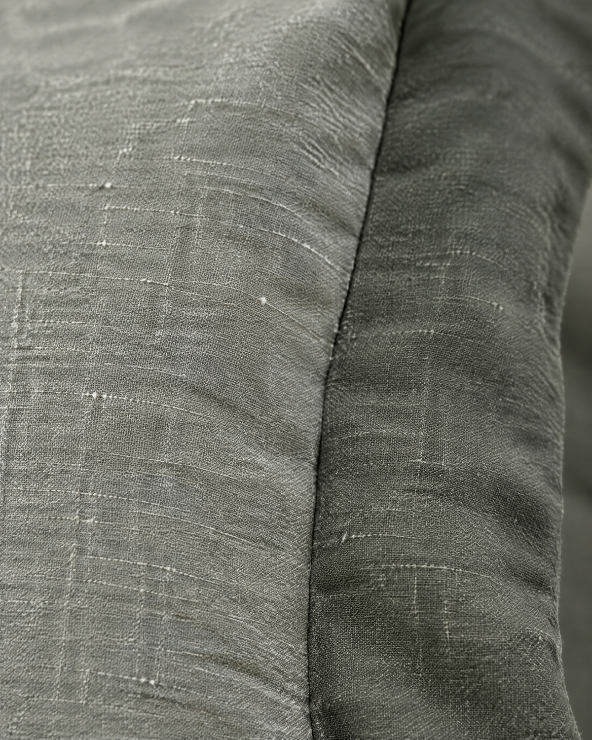 Close-up of sage two-tone flanged cushion cover