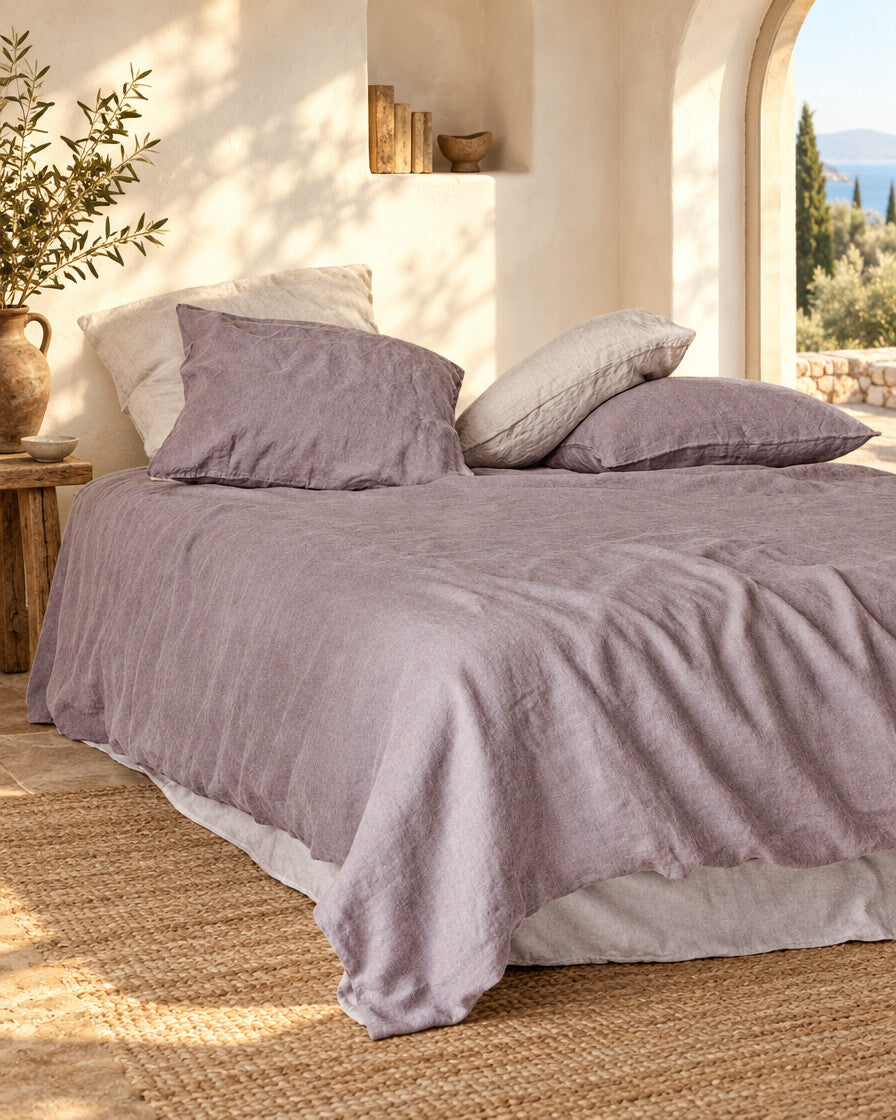 Pale mauve-grey French linen duvet cover, styled in a sun-washed Mediterranean bedroom