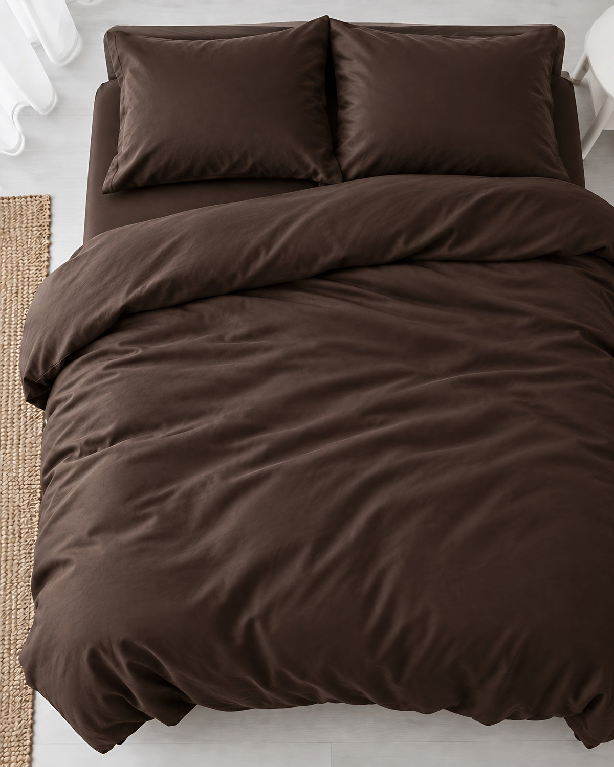 Overhead view of a Chocolate silky cotton duvet cover and two matching pillows on a made bed