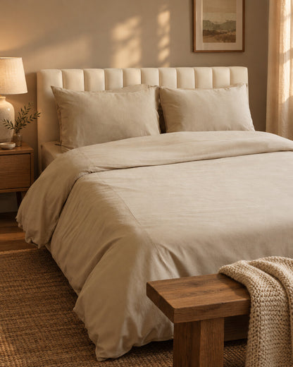 Sand plain cotton fitted sheet, styled in a cosy contemporary bedroom