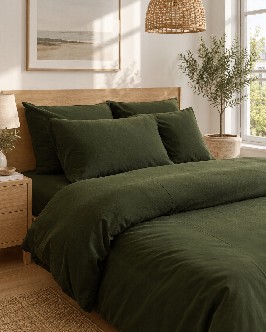Forest green plain cotton pillows and duvet, styled in a bright modern townhouse bedroom