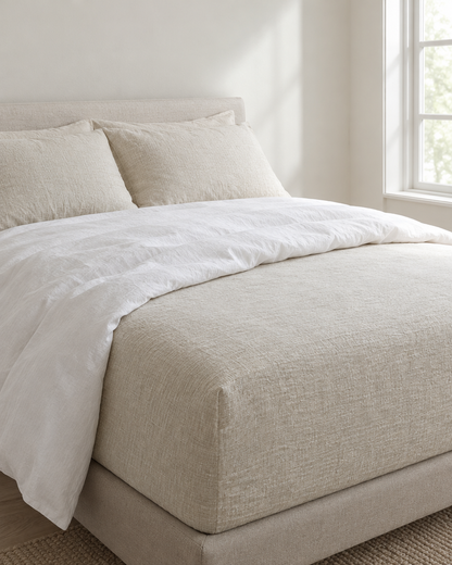 Cream Fitted Sheet - Cloud Cotton made up on a bed in a calm, light bedroom