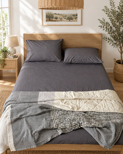 Charcoal grey plain cotton flat sheet, styled in a bright modern townhouse bedroom