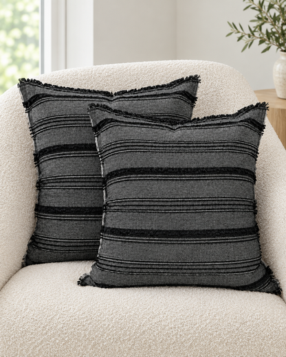 Two Fringed Stripe Linen Viscose cushion covers on a cream bouclé armchair