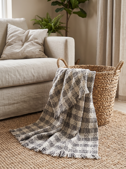 Monochrome Check Wool Mohair Throw Blanket in a seagrass basket by the sofa