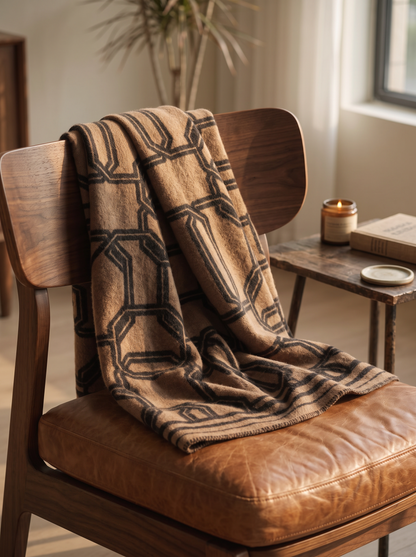 Brown Geometric Wool Throw Blanket over a walnut and leather lounge chair