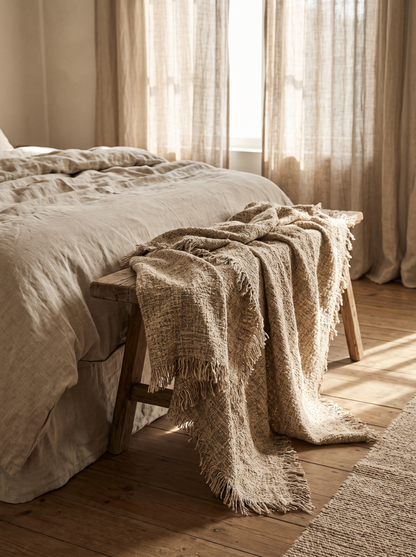 Toffee Textured Throw Blanket draped over a bench at the end of a bed