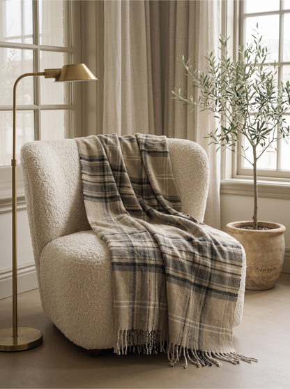 Olive Plaid Wool Blend Throw Blanket over a boucle armchair by a window