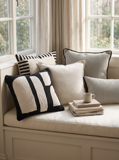 Ivory & Black Embroidery Cotton Cushion Covers on a window seat
