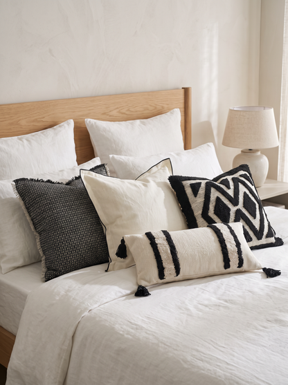 Ivory & Black Banded Tufted Embroidery Lumbar Cushion Covers on a made bed