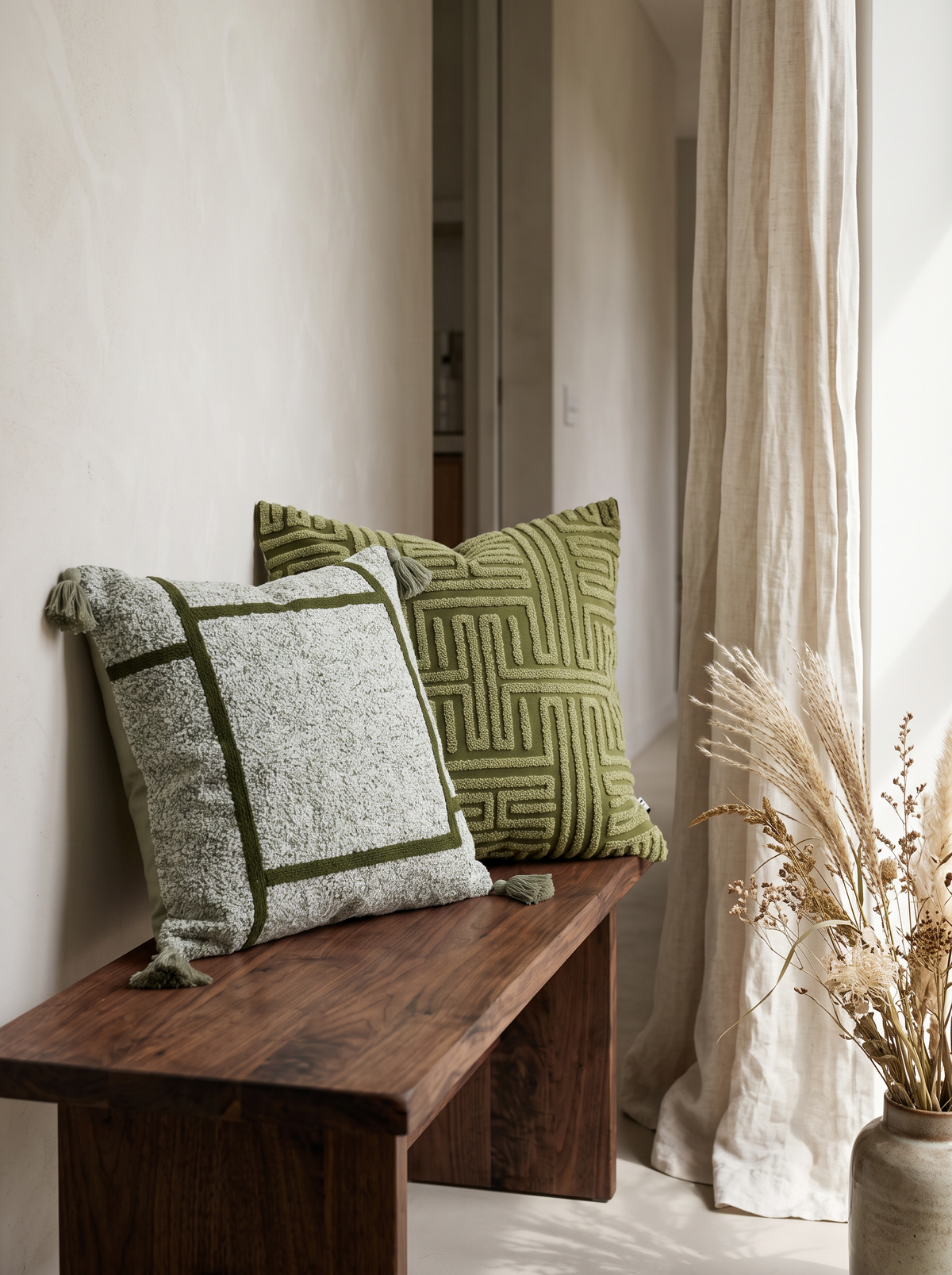 Moss Green Maze Embroidery Cushion Covers on a walnut bench