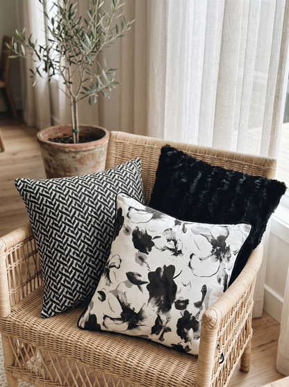 Black Faux Fur Cushion Covers on a rattan armchair by a window