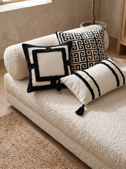 Ivory & Black Framed Tufted Embroidery Cushion Covers on a boucle daybed