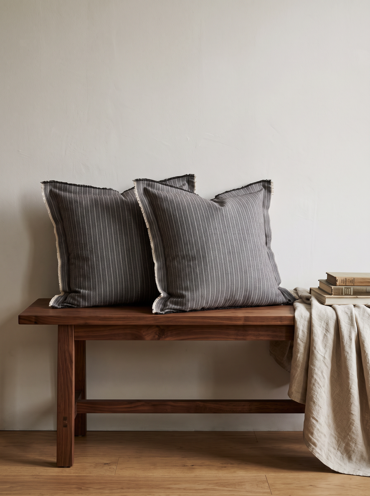 Grey Pinstripe Embroidery Cotton Linen Cushion Covers, styled at home on a walnut bench