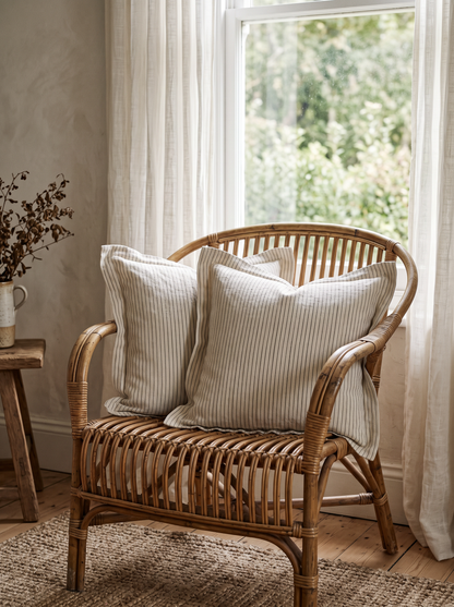 Cream Stripe Jacquard Viscose Linen Cushion Covers, styled at home on a rattan armchair by a window
