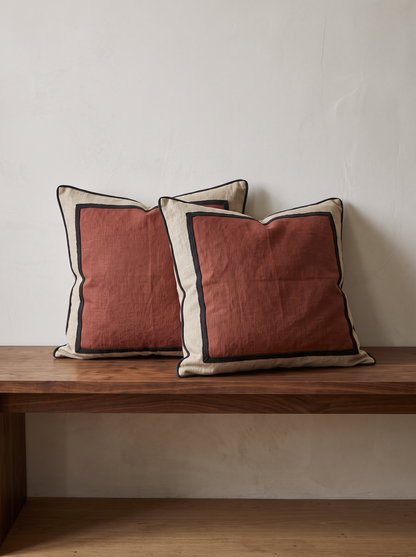 Framed Border Jacquard Cushion Covers in Rust & Linen, styled at home on a walnut bench