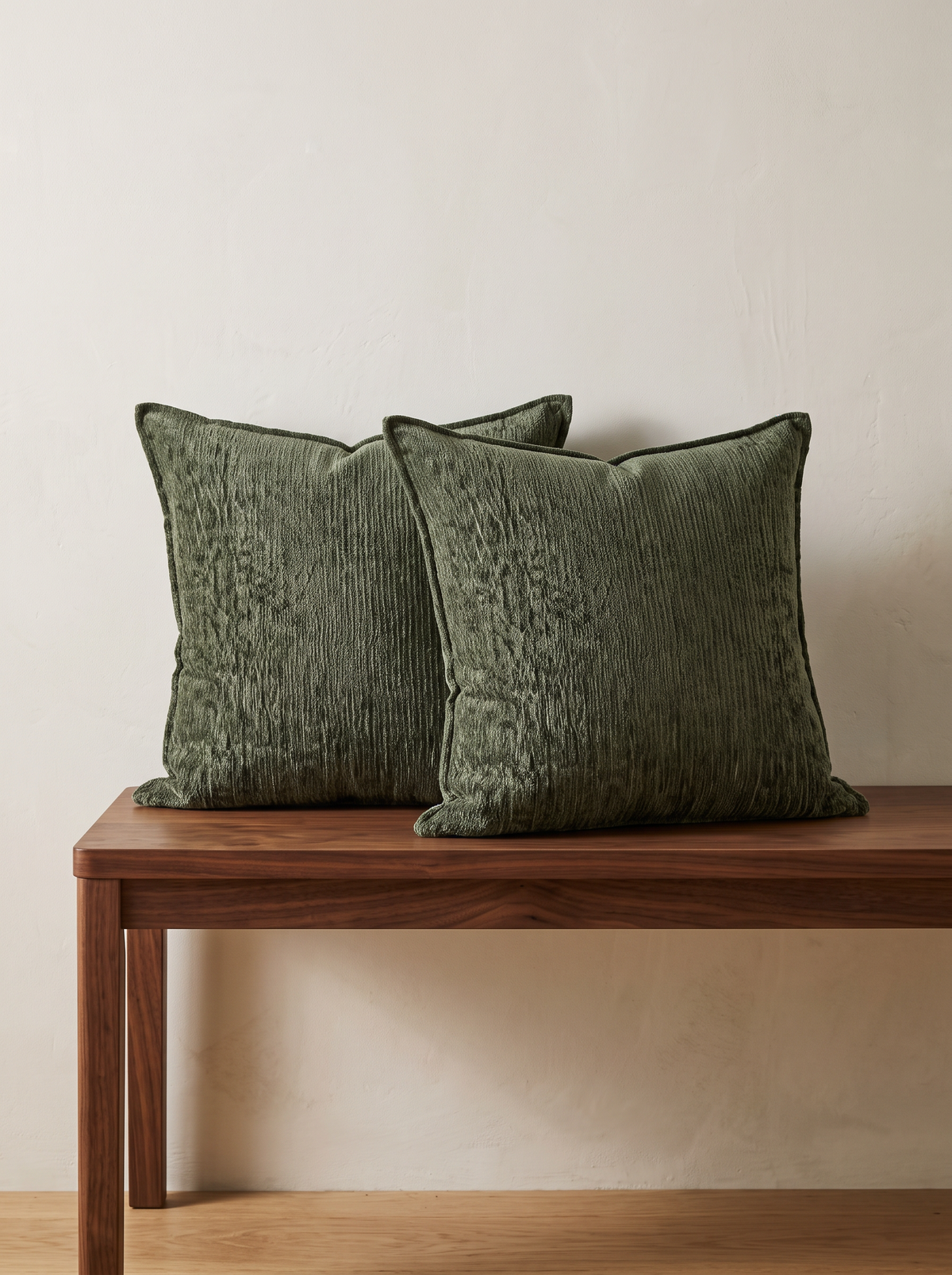 Heathered Jacquard Cushion Covers in Moss Green, styled at home on a walnut bench