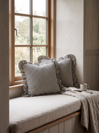 Ruffled Ticking Stripe Cotton Cushion Covers in Black, styled at home on a window seat