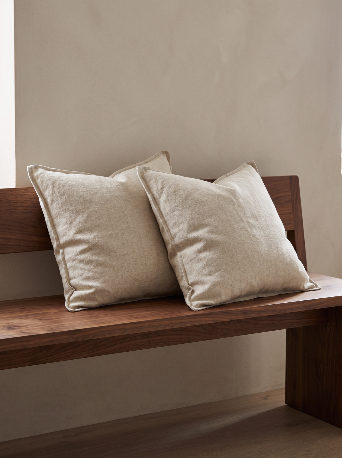 Enzyme-Washed Linen Cotton Cushion Covers in Flaxen, styled at home on a walnut bench