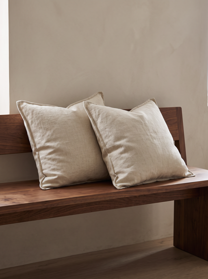 Enzyme-Washed Linen Cotton Cushion Covers in Flaxen, styled at home on a walnut bench