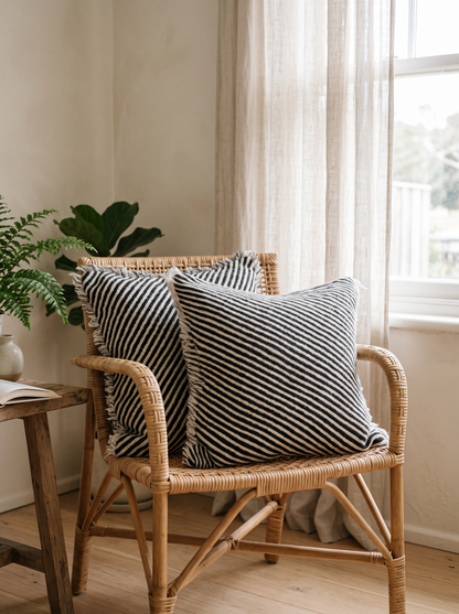 Black & Ivory Stripe Twill Weave Wool Cushion Covers, styled at home on a rattan armchair by a window