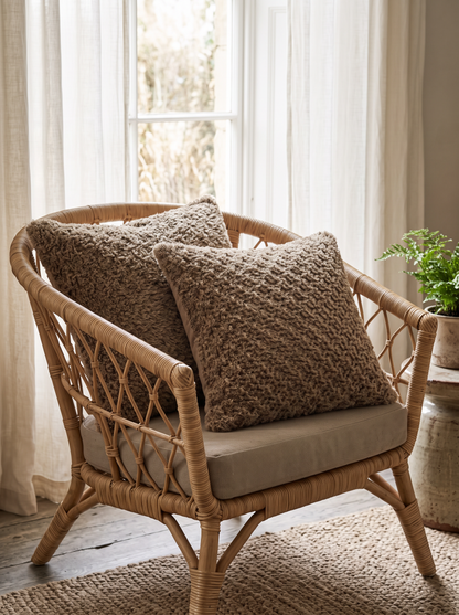 Natural Jute Honeycomb Hand-Woven Jute Cushion Covers, styled at home on a rattan armchair by a window