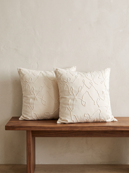 Ivory Wave Jacquard Cushion Covers, styled at home on a walnut bench