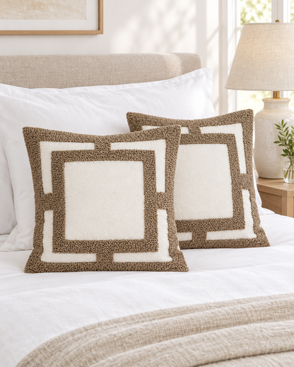 Ivory cushions framed in caramel loop-pile tufting on a made bed with white linen and a bedside lamp