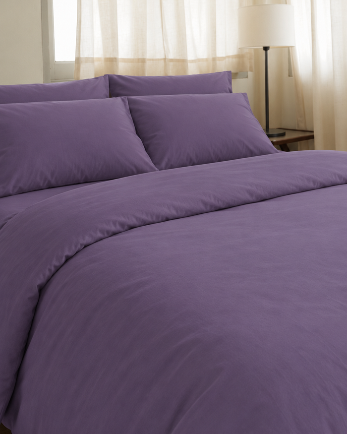 Lavender Plain Cotton duvet cover, fitted sheet and pillowcases on a made double bed