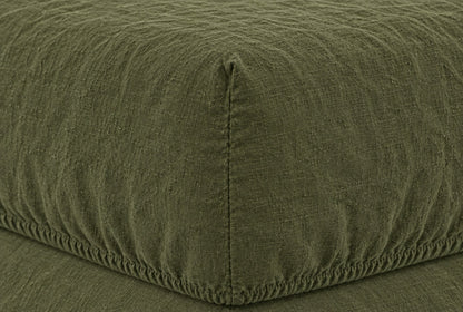 Macro of the elasticated corner and stitched seam of a Moss Green French linen fitted sheet on a mattress