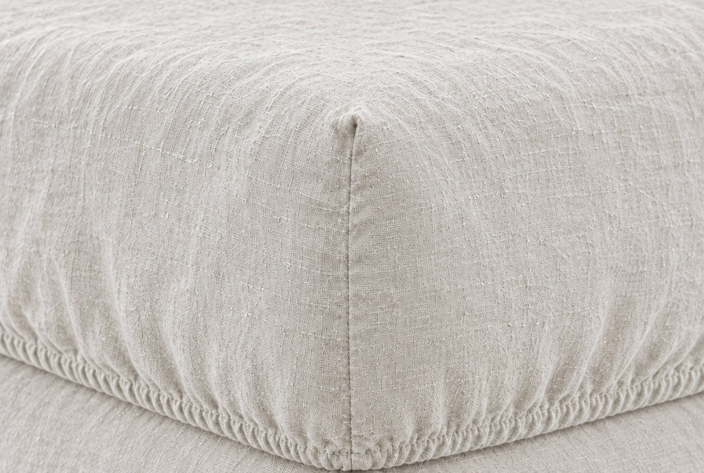 Macro of the elasticated corner and stitched seam of a Snow French linen fitted sheet on a mattress