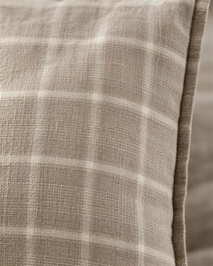 Macro close-up of the Taupe Check printed linen, the open linen weave showing through the soft taupe and ivory check beside the flange edge