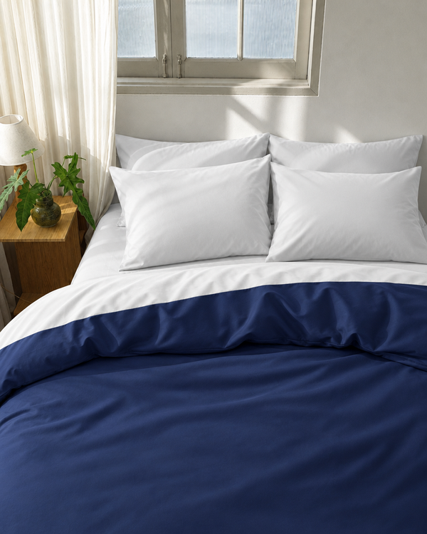 Marine Blue duvet cover with milky white reverse, milky white fitted sheet and milky white pillowcases in Silky Cotton