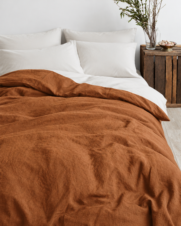Terracotta French linen duvet cover over an off white Plain Cotton percale sheet and pillows